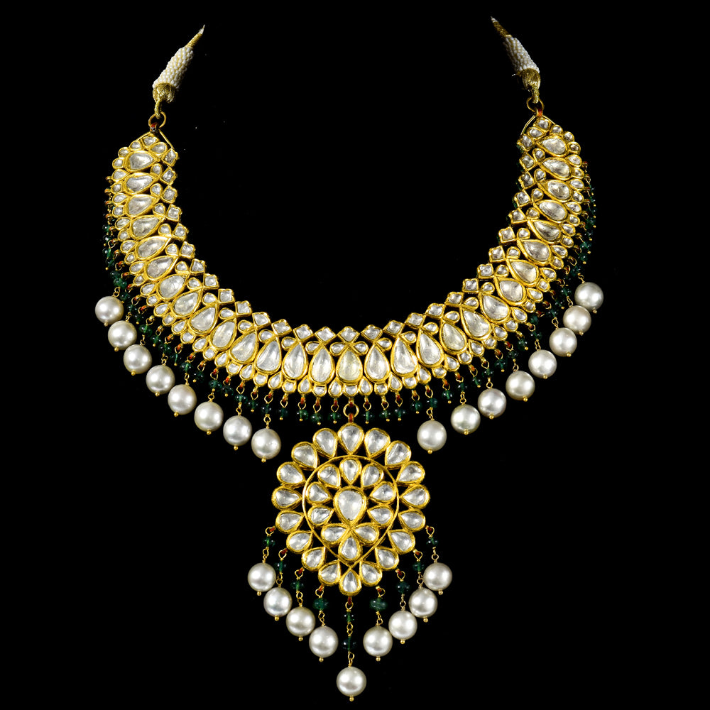Graceful Ekposta necklace and earring pair adorned with radiant diamond polki, delicate pearl stringing, and vibrant emerald beads - KMNE3496