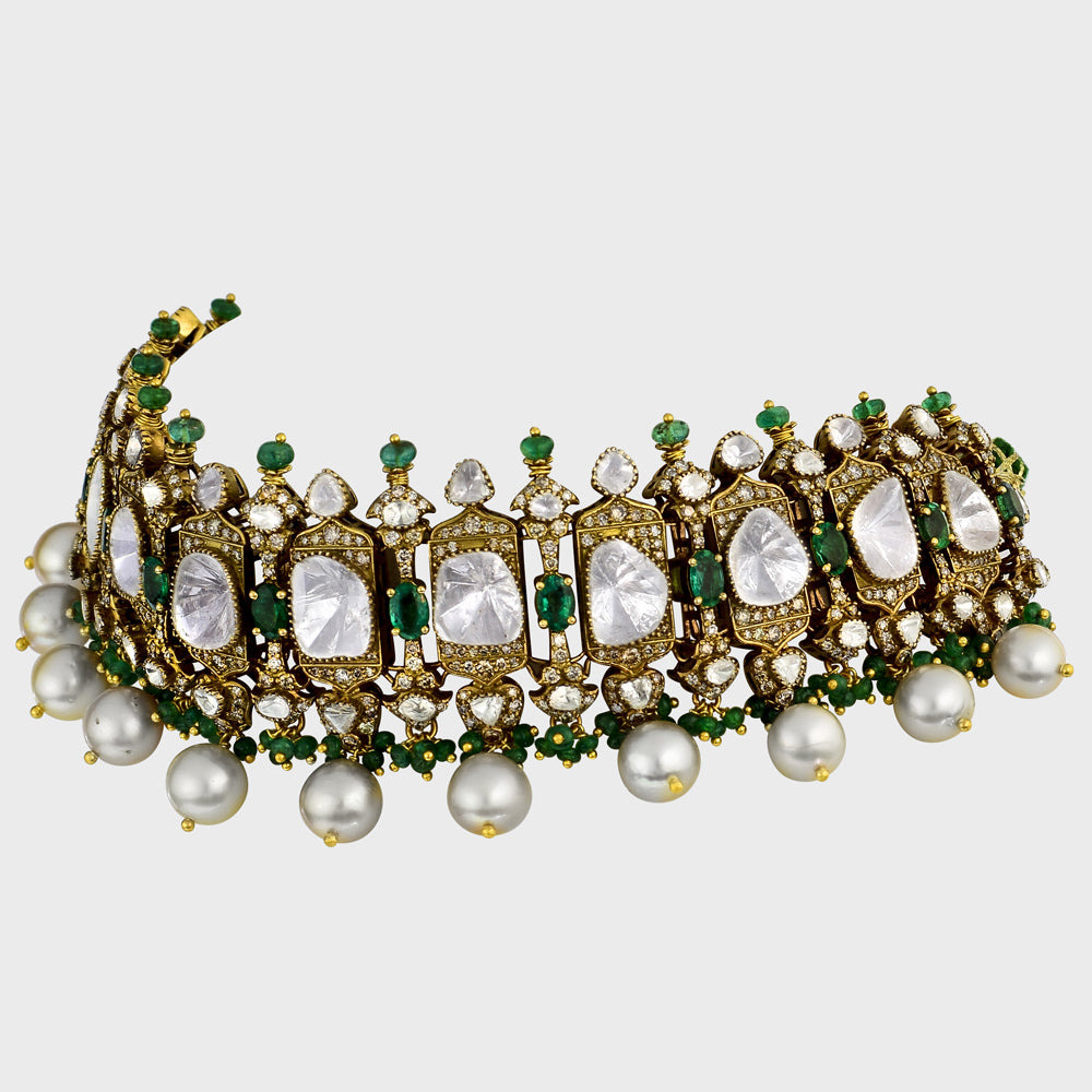 Exquisite flexible big Polki choker and earring set in fusion style, adorned with dazzling diamond rounds and emeralds. Elegantly strung with South Sea pearls and emerald beads - KMNE3565