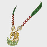 Grace your jewelry collection with this exquisite designer peacock necklace and earring set, featuring dazzling diamond rounds, radiant diamond Polki, and vibrant emeralds and rubies - KMNE3529
