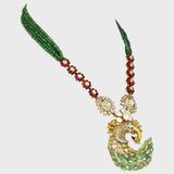 Grace your jewelry collection with this exquisite designer peacock necklace and earring set, featuring dazzling diamond rounds, radiant diamond Polki, and vibrant emeralds and rubies - KMNE3529