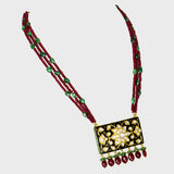 Elegant black Meena pendant and tops set, adorned with dazzling diamond Polki and gracefully strung with emerald and ruby beads. - KMPE1319