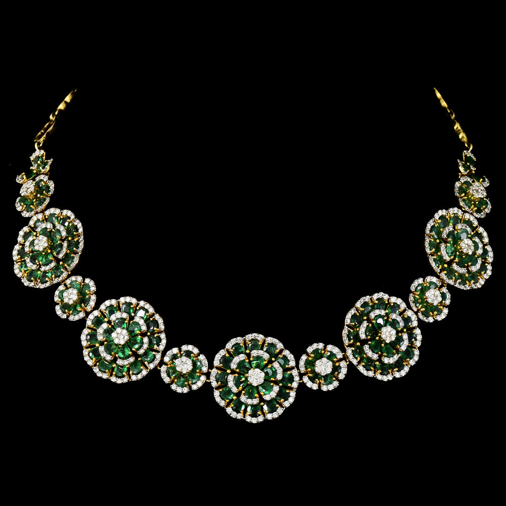 Exquisite diamond and emerald jewelry set featuring a floral-inspired necklace, earrings, and ring. - pgdne0136