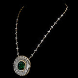 Stunning pendant featuring a bold oval-cut emerald, elegantly set with dazzling diamonds on a gold and diamond chain. - PGDPE0117