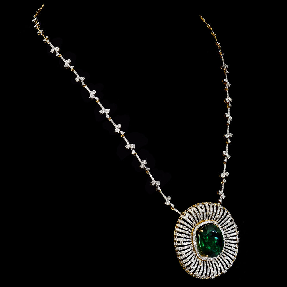 Stunning pendant featuring a bold oval-cut emerald, elegantly set with dazzling diamonds on a gold and diamond chain. - PGDPE0117
