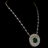 Stunning pendant featuring a bold oval-cut emerald, elegantly set with dazzling diamonds on a gold and diamond chain. - PGDPE0117