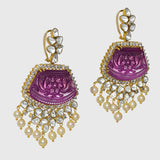 our luxurious long earrings adorned with intricately carved ruby stones, shimmering diamond polki, and radiant diamond rounds. Complete with delicate pearl hangings, these earrings exude timeless sophistication and charm. (GDE0437)