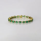 Radiate timeless elegance with this exquisite emerald and diamond bangle, where vibrant green gemstones and dazzling diamonds create a refined statement of luxury and grace.(GDBR0068)