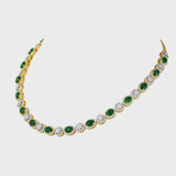 Enchant with elegance in our Emerald oval and diamond necklace and earring pair. Each piece exudes timeless sophistication and luxury.(GDNE0470)