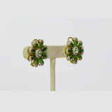 An exquisite necklace and earring set featuring oval emeralds with mutual-cut diamond centres, accented by round diamonds for timeless elegance, luxurious brilliance, and sophisticated charm. (GDNE0535)