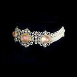 A beautifully structured choker featuring blush rose quartz centers, framed with polki and round diamonds, paired with matching statement earrings. (GDNE0542)