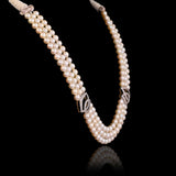 A classic three-string pearl necklace adorned with dazzling round diamonds, designed for graceful elegance and everlasting beauty.(GDNE0545)