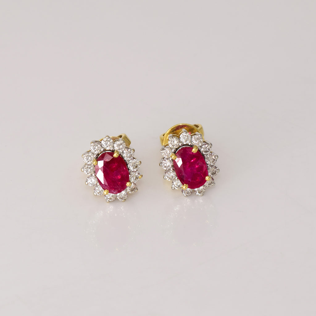 Ruby & Diamond Stud Earrings Classic ruby and diamond stud earrings showcasing vivid rubies surrounded by brilliant diamonds, perfect for adding timeless luxury to every look.(GDNE0547)