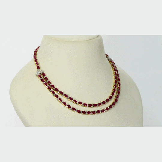 Ruby Radiance Double-Line Necklace Set A captivating double-line necklace showcasing vibrant oval rubies and sparkling diamonds, paired with elegant matching earrings for timeless glamour, sophistication, and luxurious brilliance.(GDNE0548)