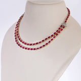 Ruby Radiance Double-Line Necklace Set A captivating double-line necklace showcasing vibrant oval rubies and sparkling diamonds, paired with elegant matching earrings for timeless glamour, sophistication, and luxurious brilliance.(GDNE0548)