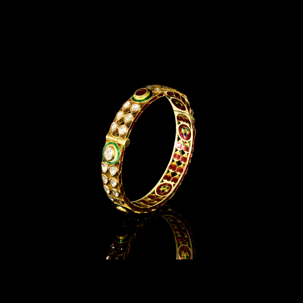 Traditional Jadau bangle adorned with uncut polki diamonds, teardrop motifs, and striking green enamel detailing. A timeless piece reflecting regal Rajasthani craftsmanship and heritage elegance.(KMB0513)