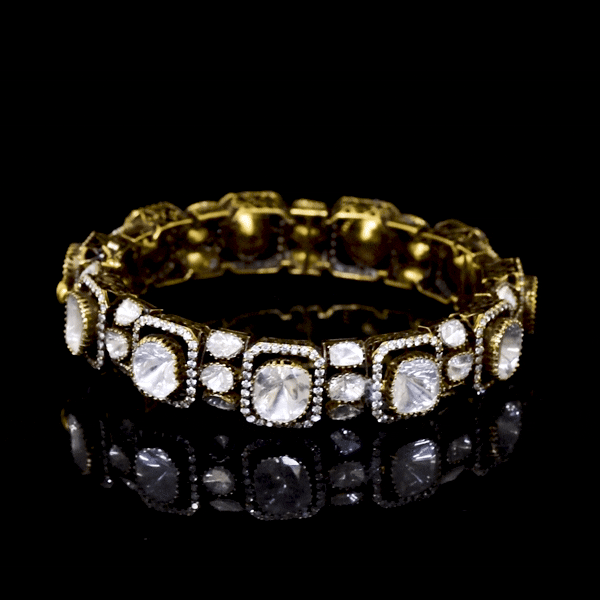 Elegant antique gold bangle featuring large square polki diamonds accented with fine detailing. A timeless piece that reflects royal heritage and impeccable craftsmanship for special occasions.(KMB0586)