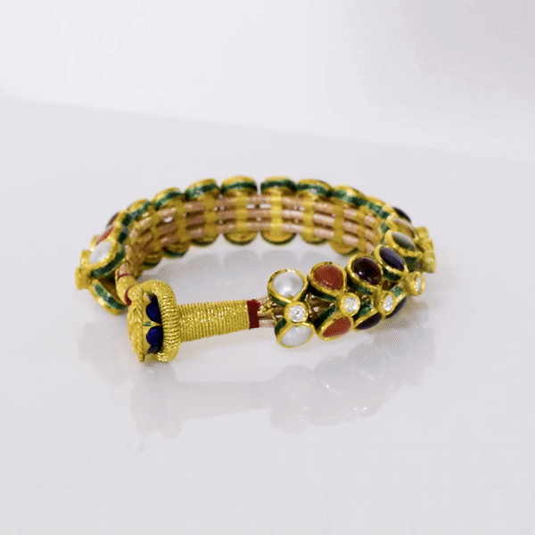 Vibrant gold Pounchi Bangle adorned with Nine gemstones, uncut polki. A festive, traditional masterpiece reflecting rich Indian heritage and intricate craftsmanship.(KMB0594)