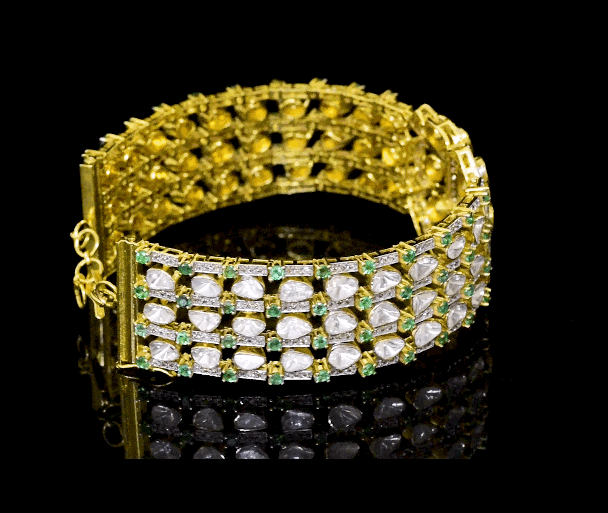 This elegant fusion-style, unique design  necklace cum bracelet, , adorned with sparkling diamond Polki, round diamonds, and vivid emeralds. A perfect blend of modern flair and traditional charm.(KMBR0148)