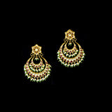 Stunning chandbali earrings adorned with sparkling Polki diamonds, rich red stones, and delicate pearl hangings, beautifully crafted to add royal elegance and festive charm to every celebration.(KME2524)