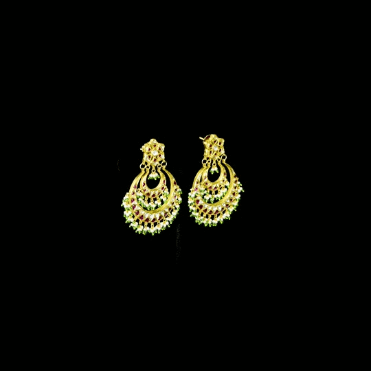 Stunning chandbali earrings adorned with sparkling Polki diamonds, rich red stones, and delicate pearl hangings, beautifully crafted to add royal elegance and festive charm to every celebration.(KME2524)