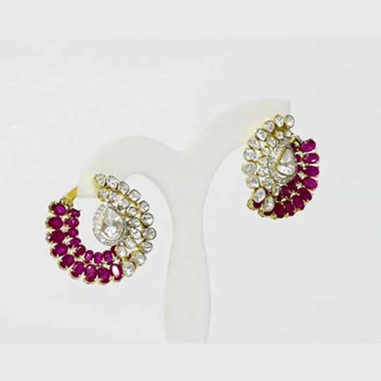 A captivating fusion design showcasing luminous Diamond Polki, sparkling diamonds, and vivid rubies, creating statement earrings perfect for every special occasion.(KME2525)