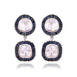 A striking harmony of natural Polki diamonds and calibre-cut blue sapphires, crafted into graceful statement earrings.(KME2562)