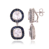 A striking harmony of natural Polki diamonds and calibre-cut blue sapphires, crafted into graceful statement earrings.(KME2562)