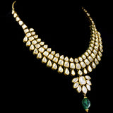 Radiate timeless elegance with our exquisite necklace set, featuring shimmering diamond polki complemented by the enchanting allure of emerald maniyas.(KMNE2892)