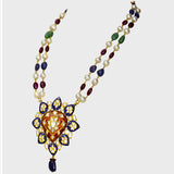 Red and blue Meena big pendant, adorned with dazzling diamond polki, strung alongside the rich hues of emerald, ruby, sapphire, and the lustrous elegance of South Sea pearls.(KMNE3406)
