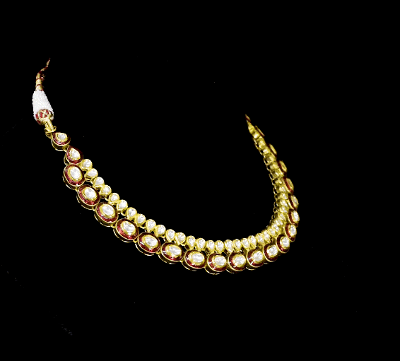 Radiate regal charm with this stunning red enameled necklace and earring set, intricately crafted with uncut diamonds. A perfect blend of heritage and glamour for festive occasions and bridal elegance. (KMNE3553)