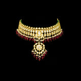 This white choker necklace and jhoomki pair is beautifully crafted with uncut diamonds, and strung with rubies and pearls. A perfect blend of elegance and tradition for weddings and festive occasions.(KMNE3585)