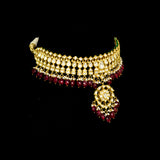 This white choker necklace and jhoomki pair is beautifully crafted with uncut diamonds, and strung with rubies and pearls. A perfect blend of elegance and tradition for weddings and festive occasions.(KMNE3585)