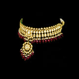 This white choker necklace and jhoomki pair is beautifully crafted with uncut diamonds, and strung with rubies and pearls. A perfect blend of elegance and tradition for weddings and festive occasions.(KMNE3585)