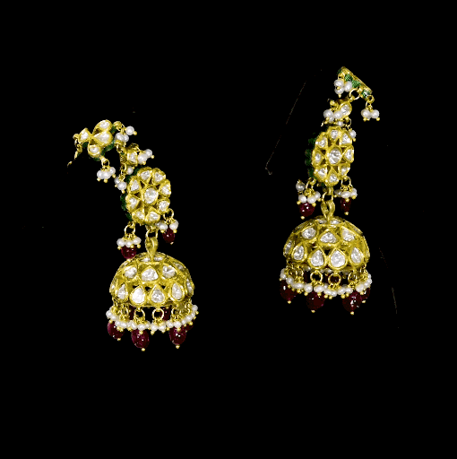 This white choker necklace and jhoomki pair is beautifully crafted with uncut diamonds, and strung with rubies and pearls. A perfect blend of elegance and tradition for weddings and festive occasions.(KMNE3585)