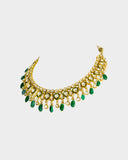 An elegant necklace and earring set featuring diamond polki framed by a vivid green circle, strung with emerald maniya and pearls. Blending heritage craftsmanship with refined luxury, it’s perfect for graceful, modern celebrations. (KMNE3588)