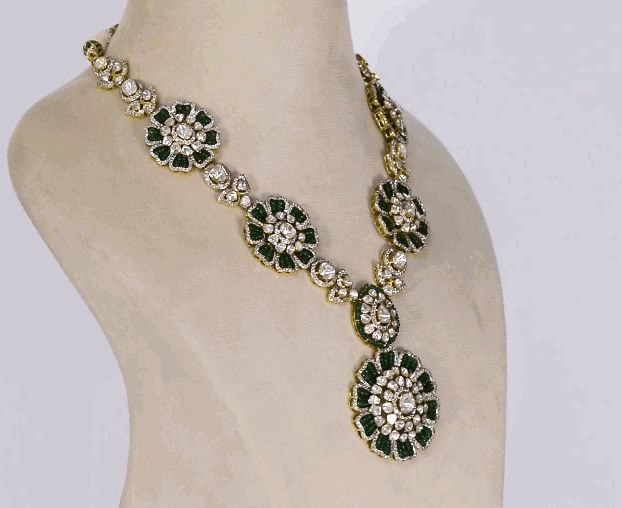 Make a bold statement with this stunning fusion-style necklace set, featuring a dazzling blend of diamond polki, round diamonds, and rich emerald beads. A perfect mix of tradition and modern glamour.(KMNE3592)