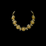 Delicate and dazzling, this necklace and earring pair features uncut diamond polki in an elegant open setting, crafted in a graceful floral design. A perfect blend of timeless beauty and fine craftsmanship for special occasions and celebrations.(KMNE3596)