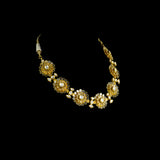 Delicate and dazzling, this necklace and earring pair features uncut diamond polki in an elegant open setting, crafted in a graceful floral design. A perfect blend of timeless beauty and fine craftsmanship for special occasions and celebrations.(KMNE3596)