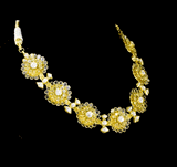 Delicate and dazzling, this necklace and earring pair features uncut diamond polki in an elegant open setting, crafted in a graceful floral design. A perfect blend of timeless beauty and fine craftsmanship for special occasions and celebrations.(KMNE3596)