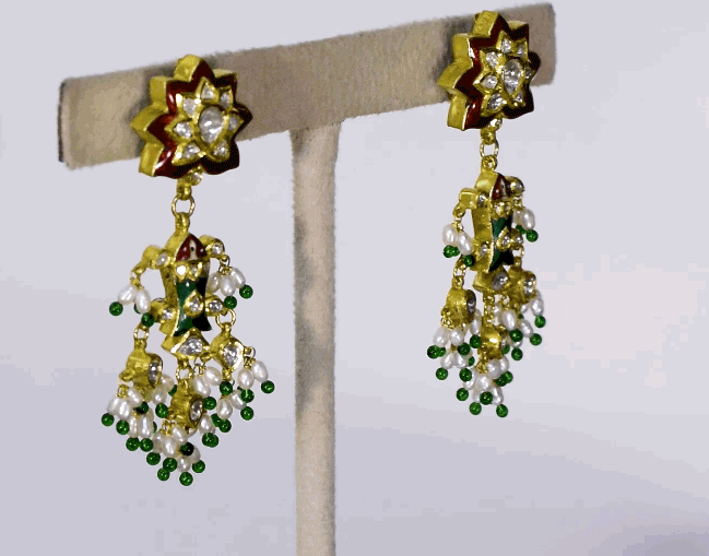 Celebrate tradition with this vibrant multi-color enameled long necklace and earring pair, adorned with uncut diamonds and pearls. Featuring intricate fish design links and a majestic peacock pendant. (KMNE3605)