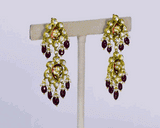 Beautiful red enameled flower design necklace and earrings set with sparkling uncut diamond polki, strung with ruby maniya and pearls. Perfect to add a touch of tradition and elegance to any special occasion.(KMNE3608)