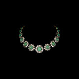 Discover refined elegance with this fusion-style necklace set, featuring a carved emerald centerpiece surrounded by uncut diamond Polki. A perfect harmony of tradition and modernity, crafted to make a statement.(KMNE3614)