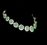 Discover refined elegance with this fusion-style necklace set, featuring a carved emerald centerpiece surrounded by uncut diamond Polki. A perfect harmony of tradition and modernity, crafted to make a statement.(KMNE3614)