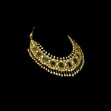 Make a majestic statement with this grand necklace set, featuring uncut diamond Polki, a striking emerald centerpiece, rich red stones, and delicate pearls in the funghar. A masterpiece of regal elegance.(KMNE3616)