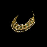 Make a majestic statement with this grand necklace set, featuring uncut diamond Polki, a striking emerald centerpiece, rich red stones, and delicate pearls in the funghar. A masterpiece of regal elegance.(KMNE3616)