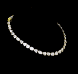 Understated elegance shines through this single-line necklace and earring pair, featuring uncut diamond Polki. A graceful blend of tradition and simplicity—perfect for intimate celebrations and timeless everyday sophistication.(KMNE3620)