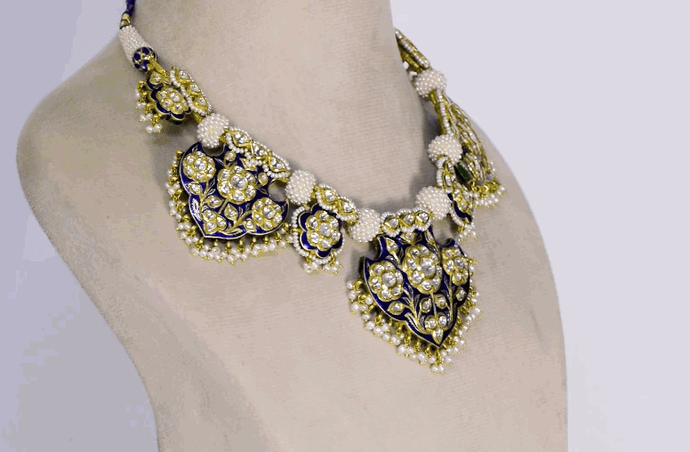 Elevate your style with this exquisite blue Meena Pankhi necklace and earring set, featuring uncut diamonds and delicate pearls. A timeless blend of traditional artistry and elegance, perfect for festive and bridal occasions.(KMNE3625) + (KME2445)