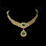 This exquisite set features luminous polki diamonds highlighted by rich green stones, embodying heritage craftsmanship and royal charm. (KMNE3675)