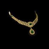 This exquisite set features luminous polki diamonds highlighted by rich green stones, embodying heritage craftsmanship and royal charm. (KMNE3675)