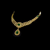 This exquisite set features luminous polki diamonds highlighted by rich green stones, embodying heritage craftsmanship and royal charm. (KMNE3675)